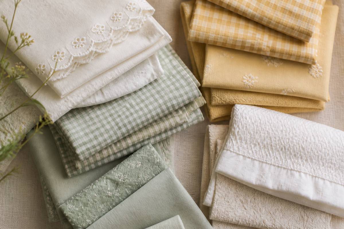 Folded smocking fabrics including Swiss batiste, imperial broadcloth, and pastel gingham