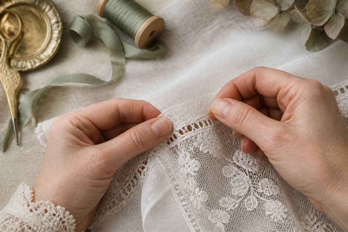 Close-up of French hand sewing joining lace to Swiss batiste with entredeux